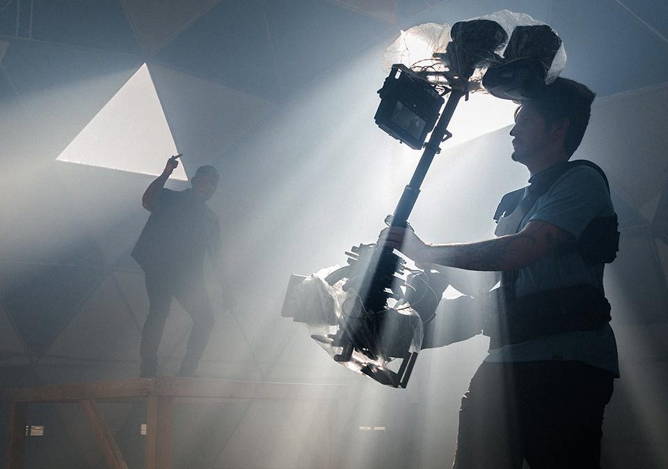 Behind the scenes image of a steadicam operator.