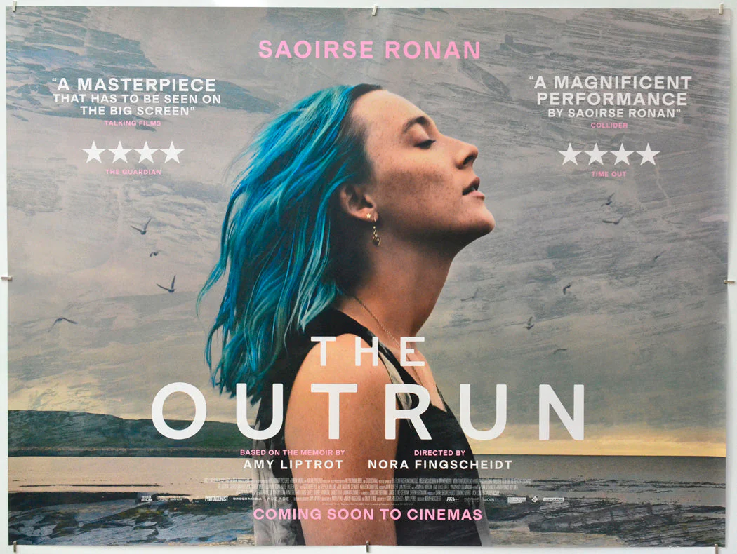 A movie poster for "The Outrun" showing lead actress Saoirse Ronan in profile, blue hair blowing in the wind, eyes closed and face tilted upward against a coastal backdrop with cliffs and sea birds.
